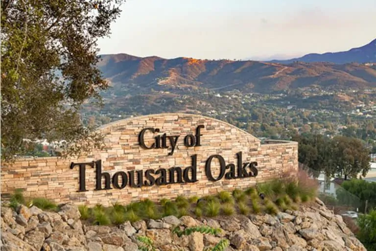 Personal Injury Trial Attorney Locations 47 City of Thousand Oaks sign, mountainous background.
